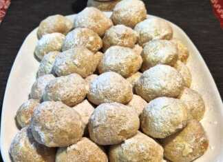 Μικρά λευκά μπισκοτάκια πασπαλισμένα με άχνη ζάχαρη, γεμιστά με ροζ λουκούμι, τοποθετημένα σε πιατέλα