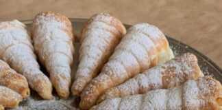 Τραγανά κορνεδάκια σφολιάτας γεμισμένα με πλούσια, λευκή κρέμα και πασπαλισμένα με ζάχαρη άχνη.