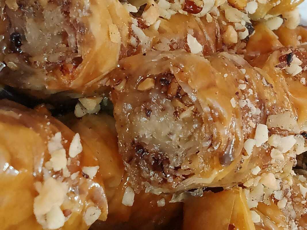 Μια σειρά από χρυσαφένια, σουρωτά σαραγλάκια μέσα στο ταψί, περιχυμένα με σιρόπι και πασπαλισμένα με τριμμένο φυστίκι ή καρύδι