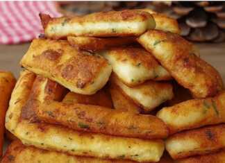 Χρυσαφένια τηγανιτά μπαστουνάκια ζύμης με λιωμένο τυρί στο εσωτερικό τους τοποθετημένα πάνω σε απορροφητικό χαρτί.