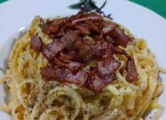 Ένα πιάτο με λιγκουίνι καρμπονάρα, καλυμμένο με τραγανό γκουαντσιάλε και φρεσκοτριμμένο πεκορίνο, που αχνίζει.