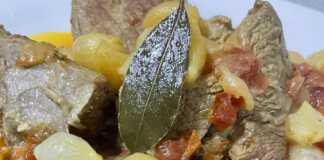 παραδοσιακό μοσχαράκι στιφάδο, όπου τα κρεμμυδάκια είναι ολόκληρα και μελωμένα μέσα σε μια πλούσια κόκκινη σάλτσα.