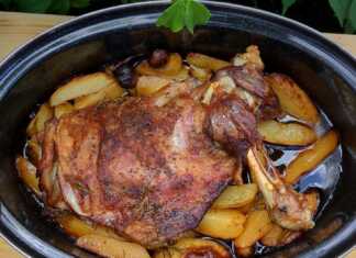 Μια ανοιχτή γάστρα με ροδοκοκκινισμένο αρνί και μελωμένες πατάτες, περιχυμένα με τη σάλτσα τους και φρέσκο δεντρολίβανο.