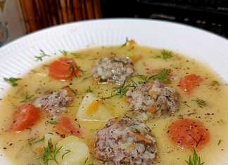 Μια βαθιά πιατέλα με ζεστά γιουβαρλάκια σε λευκή σάλτσα αυγολέμονο με κομματάκια καρότου και φρέσκο άνηθο