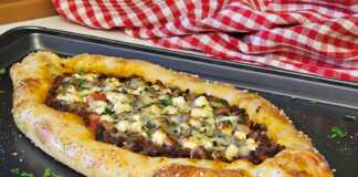 πεϊνιρλί σε σχήμα βάρκας με πλούσιο κιμά, λιωμένα τυριά και σουσάμι στην κόρα