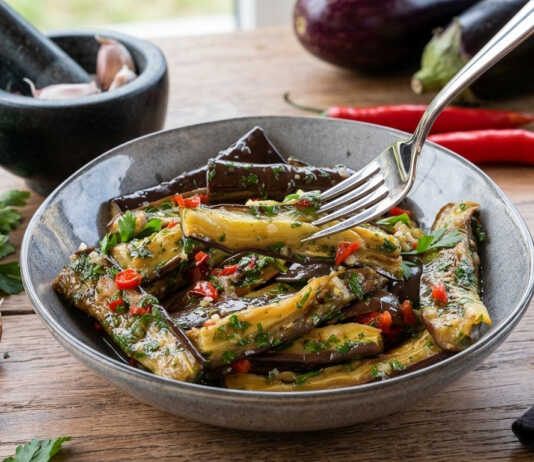 Ψημένες μπάρες μελιτζάνας μαριναρισμένες με φρέσκο βασιλικό, μαϊντανό και καυτερή πιπεριά μέσα σε γυάλινο μπολ.