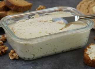 Ένα μπολ με βελούδινο σπιτικό πατέ κοτόπουλου, γαρνιρισμένο με φρέσκα μυρωδικά, δίπλα σε φρυγανισμένες φέτες ψωμιού.