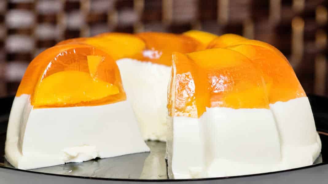 λυκό ψυγείου με πανακότα και ζελέ ροδάκινο σε πιατέλα με φέτες ροδάκινου